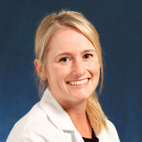 woman smiling wearing a lab coat