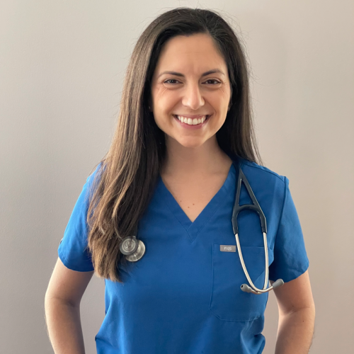 smiling woman wearing blue scrubs