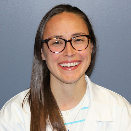 woman smiling wearing a lab coat