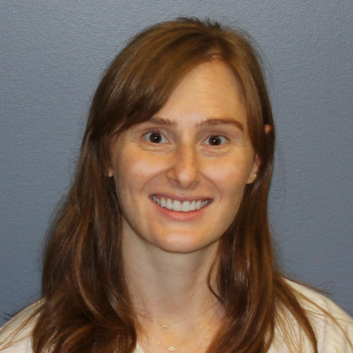 woman smiling wearing a lab coat