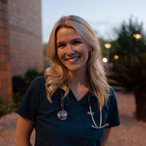woman with blond hair and blue scrubs