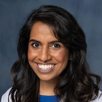 woman smiling wearing a lab coat